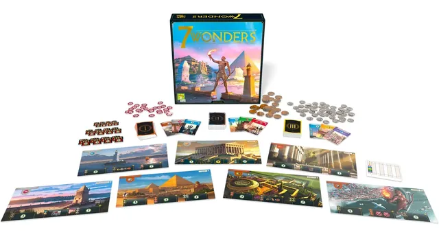 The contents laid out: seven wonder boards, card decks, coins and military tokens, with the box behind