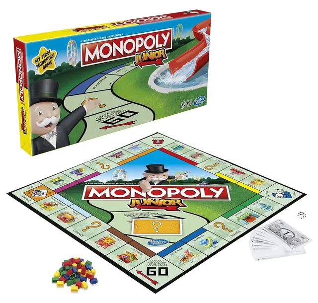 An earlier Monopoly Junior box beside its square board, small notes, Sold signs and a die