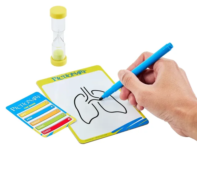 A hand drawing on an erasable board next to a sand timer and clue cards