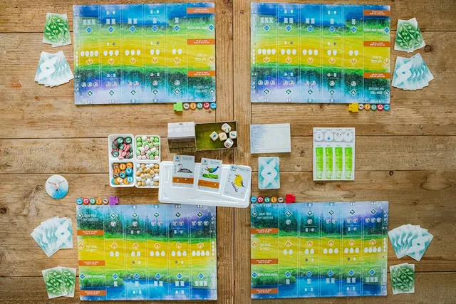 Four player mats around the bird feeder, card tray and goal board, seen from above