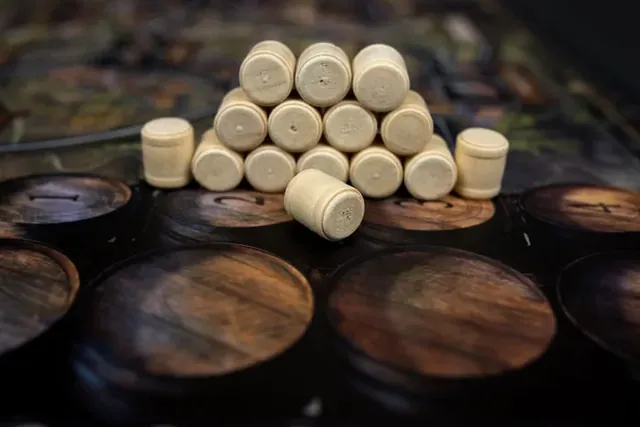 A pyramid of wooden beer barrels on the board