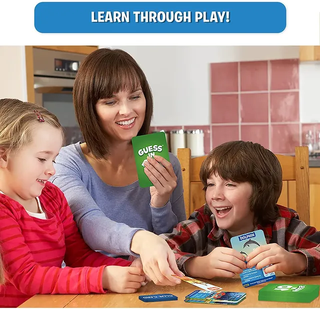 A woman and two children playing Guess in 10 with cards on a table