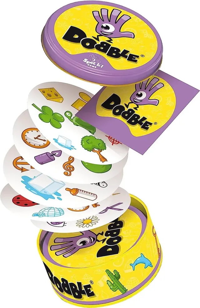 A stack of round Dobble cards rising out of the tin