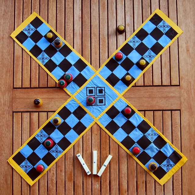 A Pachisi board with its pieces, and cowrie shells used instead of dice