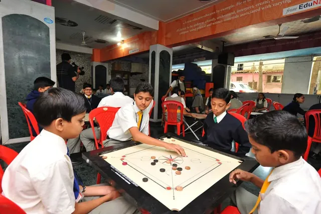Schoolboys in white uniforms playing carrom on a board set on a stand