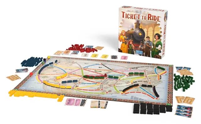 Everything in the box laid out: the map of the USA, plastic trains in five colours, train cards, destination tickets and the box